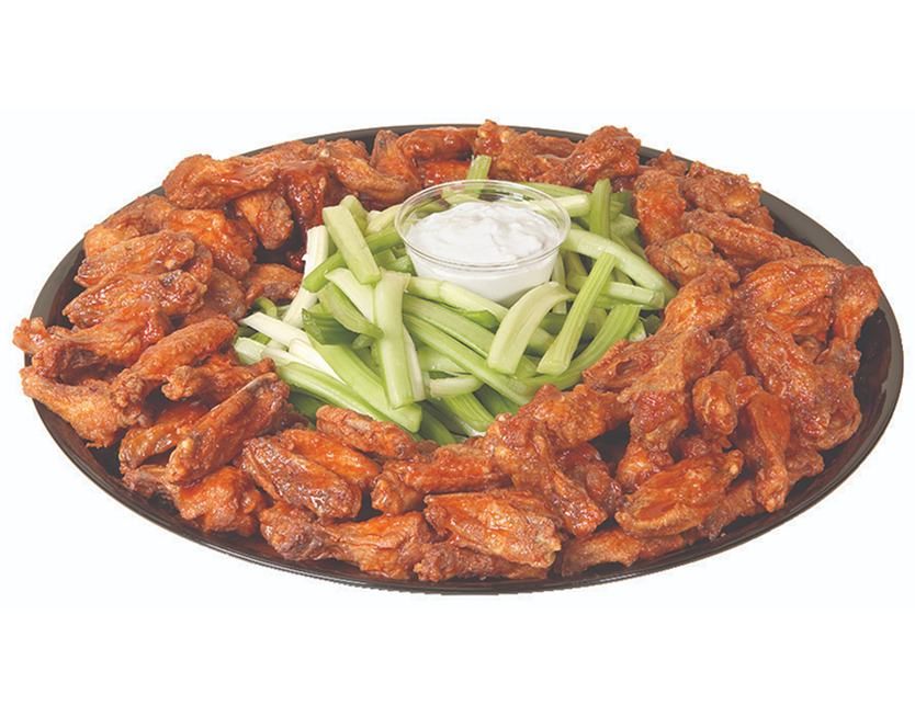 Plate of buffalo wings with celery and ranch dip