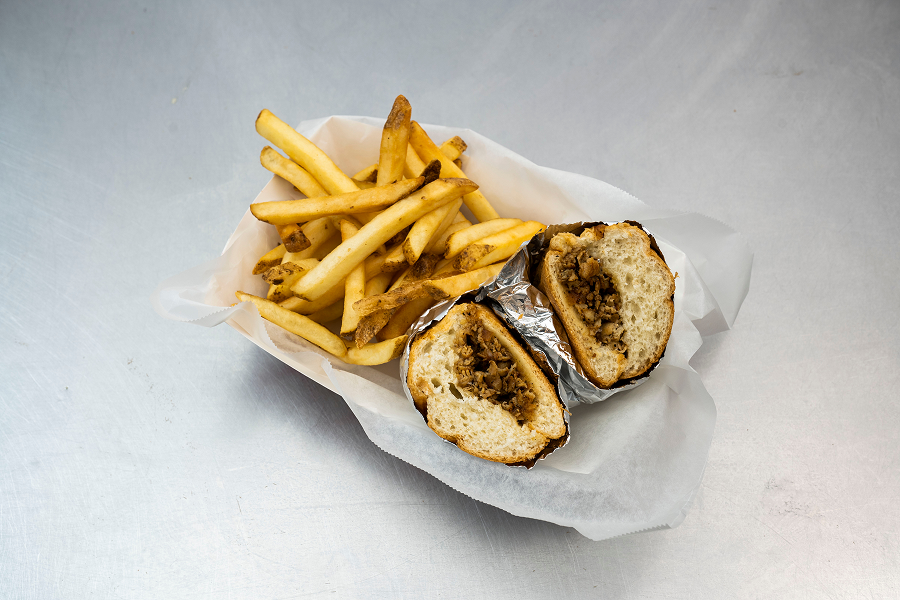 Philly cheesesteak with golden french fries